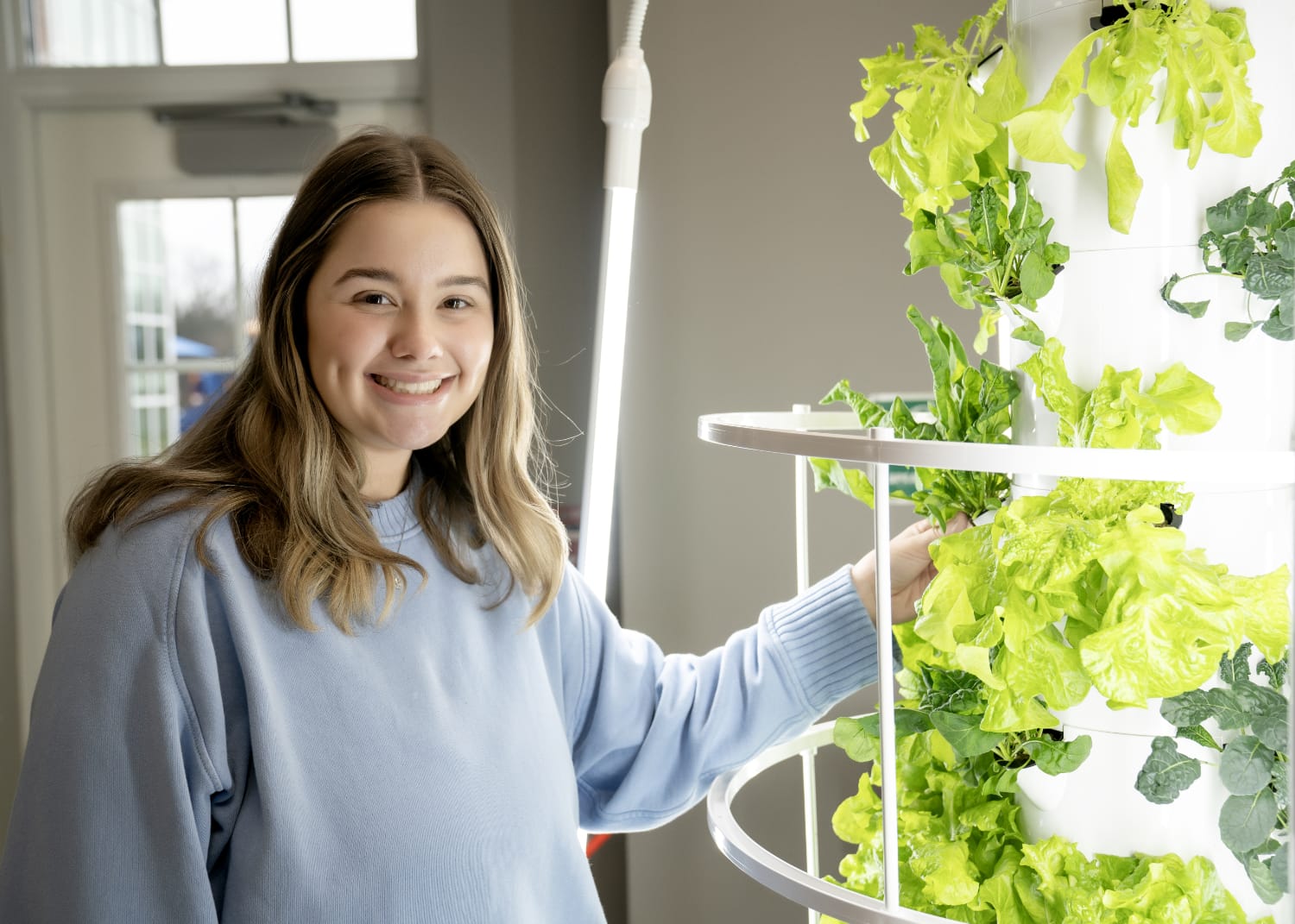 student with growing plants